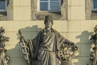 Detailed view of a classical sculpture on a historic building in Wrocław, Poland.