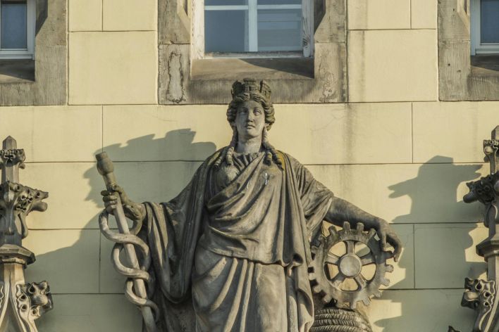 Detailed view of a classical sculpture on a historic building in Wrocław, Poland.